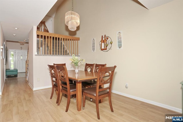 dining room with baseboards, recessed lighting, wood finished floors, and a chandelier