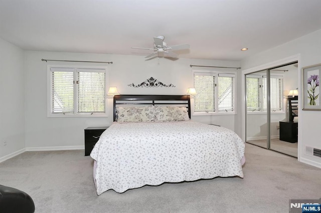 carpeted bedroom with baseboards, ceiling fan, and a closet