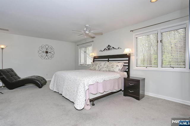 carpeted bedroom with baseboards, visible vents, and ceiling fan