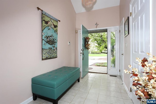 doorway to outside featuring light tile patterned flooring, visible vents, and baseboards