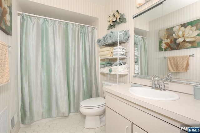 full bath with curtained shower, wallpapered walls, toilet, tile patterned floors, and vanity