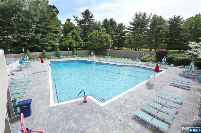 pool featuring a patio area and fence