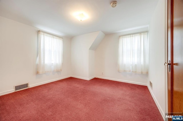 bonus room with visible vents, carpet flooring, and baseboards