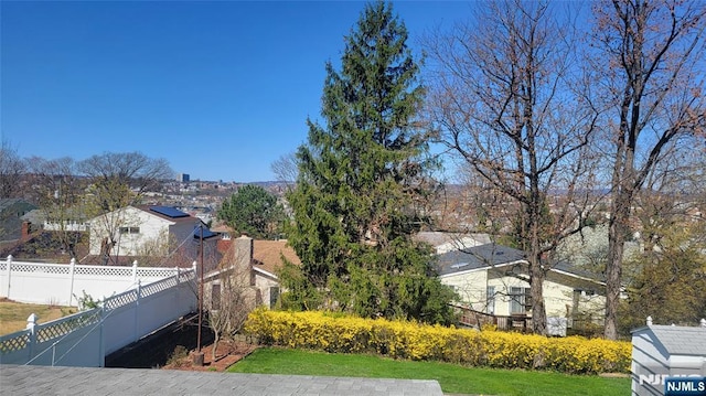 view of yard featuring fence and a residential view