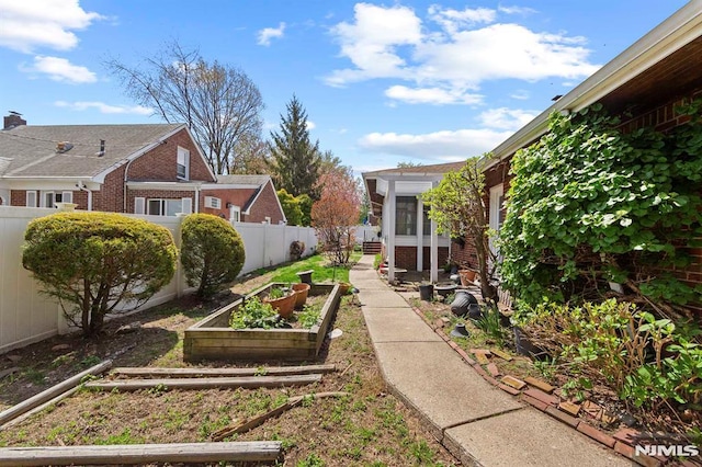 view of yard with a garden and a fenced backyard