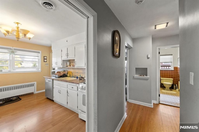 interior space featuring visible vents, radiator, baseboards, light wood-type flooring, and a notable chandelier
