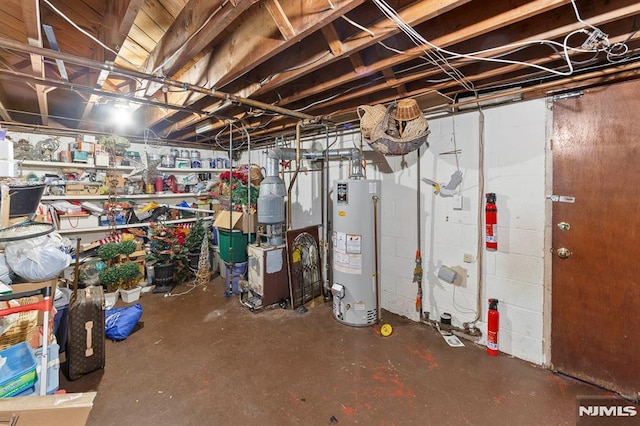 unfinished basement featuring water heater and a heating unit
