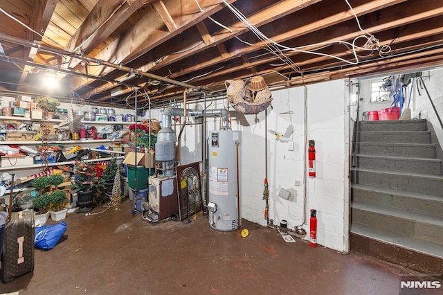 unfinished basement featuring stairway, gas water heater, and a heating unit