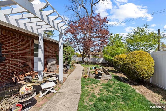 view of yard with a pergola, a garden, and a fenced backyard