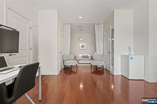 office space featuring recessed lighting, wood finished floors, and baseboards
