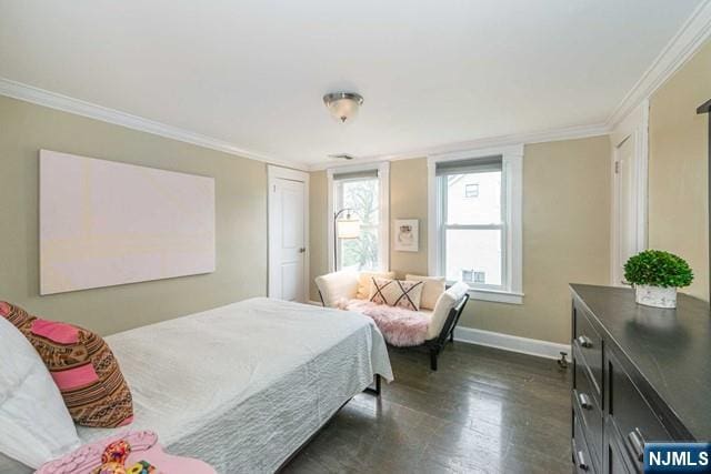 bedroom featuring crown molding, dark wood-style flooring, and baseboards