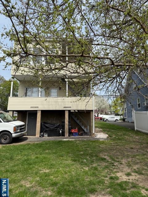 exterior space featuring a front lawn and stairs