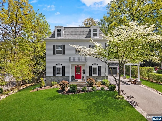 322 Maple St, Ramsey, NJ 07446 - second empire-style home with stone siding, a front yard, mansard roof, a shingled roof, and driveway