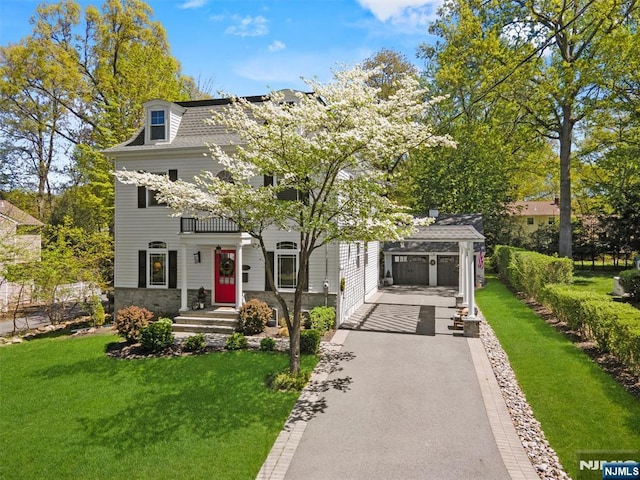 322 Maple St, Ramsey, NJ 07446 - view of front of house with aphalt driveway, stone siding, and a front yard