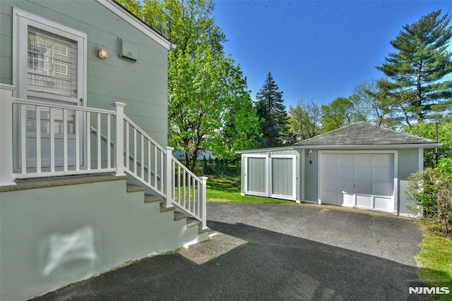 detached garage with aphalt driveway