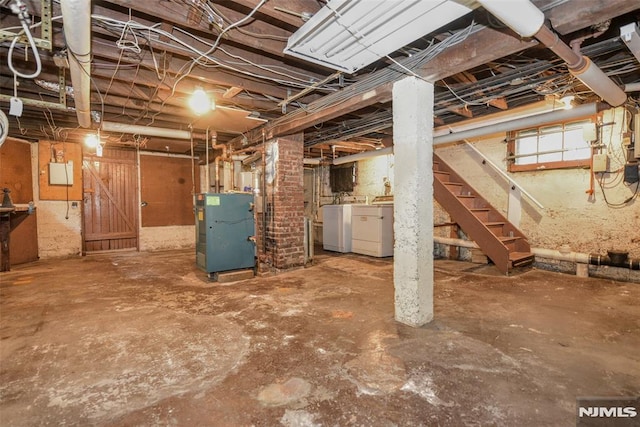 unfinished below grade area with stairs, heating unit, and washing machine and dryer