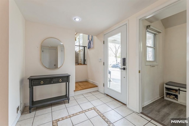 doorway to outside with recessed lighting, baseboards, and visible vents