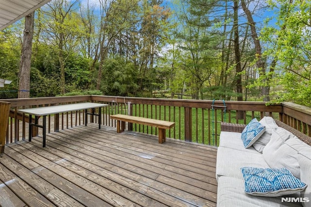 wooden terrace with a lawn