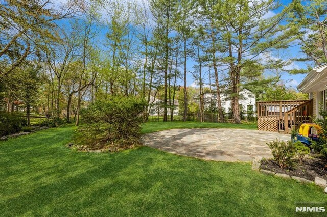 view of yard featuring a patio and a deck