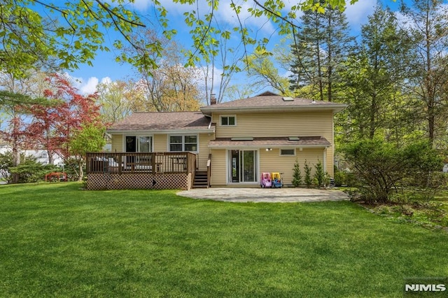 rear view of property featuring a wooden deck, a patio, a chimney, and a lawn