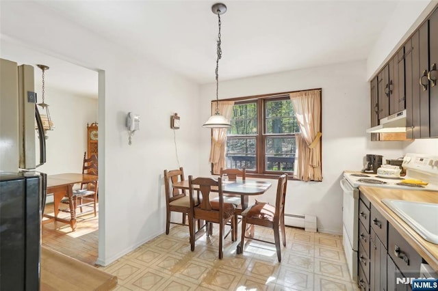 dining room featuring light floors and baseboards