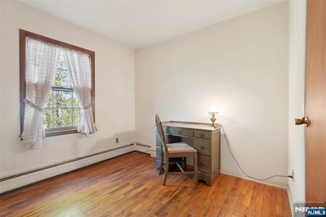 office space with a baseboard radiator and hardwood / wood-style floors