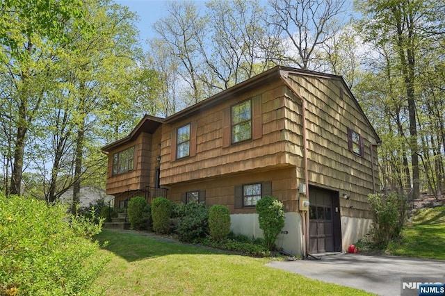 view of side of home with a yard