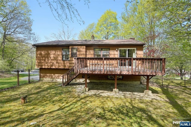 rear view of property featuring a fenced backyard, stairs, a yard, and a deck