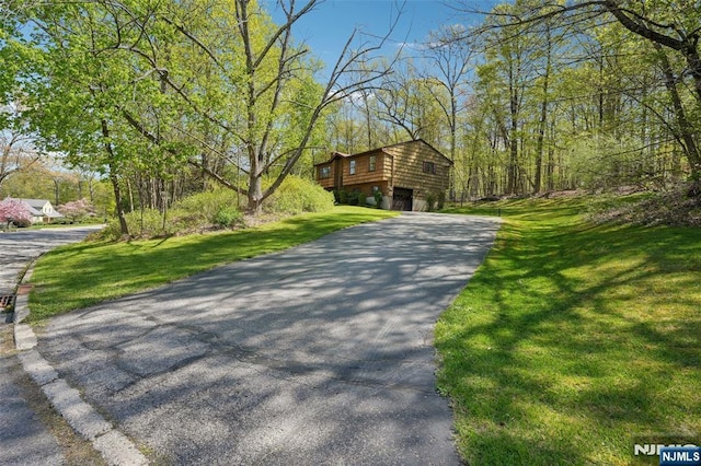 view of front of home with a front lawn and aphalt driveway