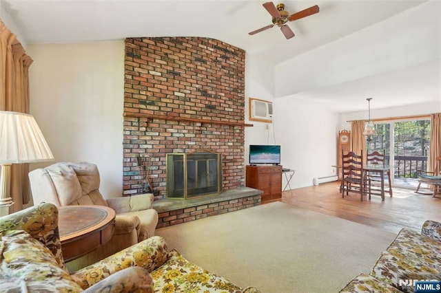 living area featuring ceiling fan, a fireplace, wood finished floors, a baseboard heating unit, and lofted ceiling