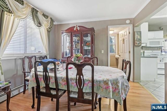 dining area featuring plenty of natural light and light wood-style flooring