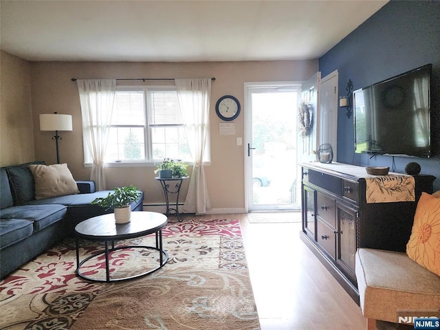 living room with light wood finished floors and baseboards