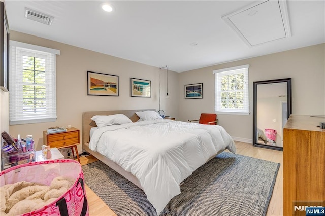 bedroom featuring attic access, recessed lighting, light wood-style flooring, and visible vents