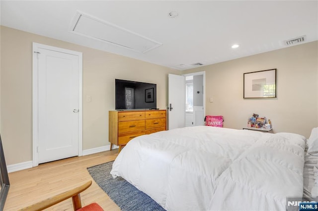 bedroom featuring recessed lighting, attic access, light wood finished floors, and visible vents