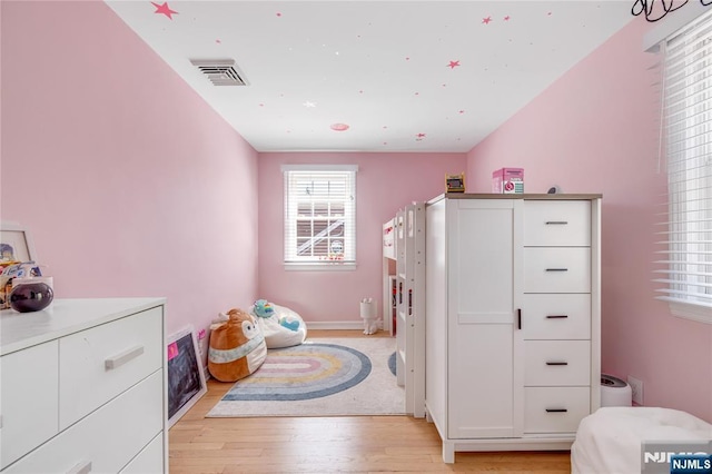 bedroom featuring visible vents and light wood-type flooring