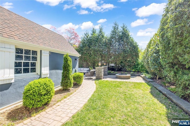 view of yard with a patio and an outdoor fire pit