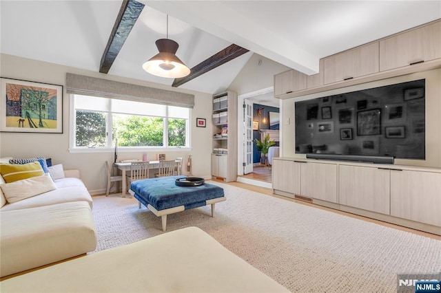 living area with baseboards and vaulted ceiling with beams