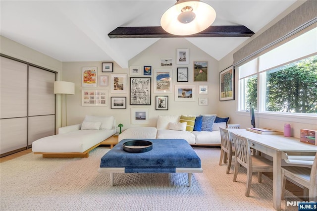 sitting room with vaulted ceiling with beams