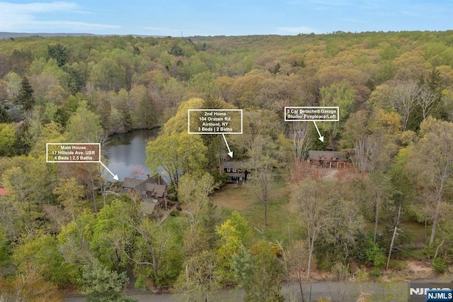 aerial view featuring a water view and a wooded view