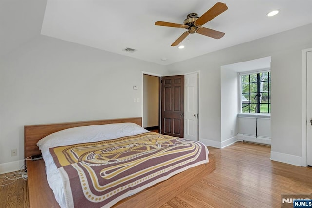 bedroom with visible vents, baseboards, baseboard heating, recessed lighting, and light wood-style flooring