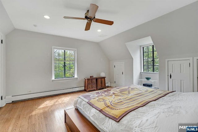 bedroom featuring recessed lighting, wood finished floors, baseboard heating, and vaulted ceiling