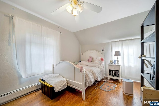 bedroom featuring ceiling fan, a baseboard radiator, wood finished floors, and lofted ceiling