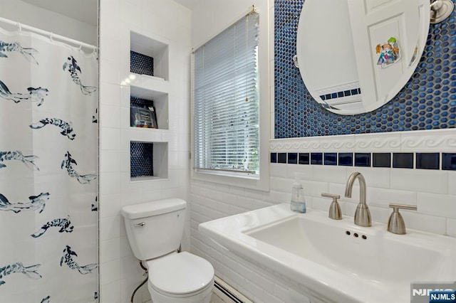 full bathroom with a sink, toilet, a shower with curtain, and tile walls
