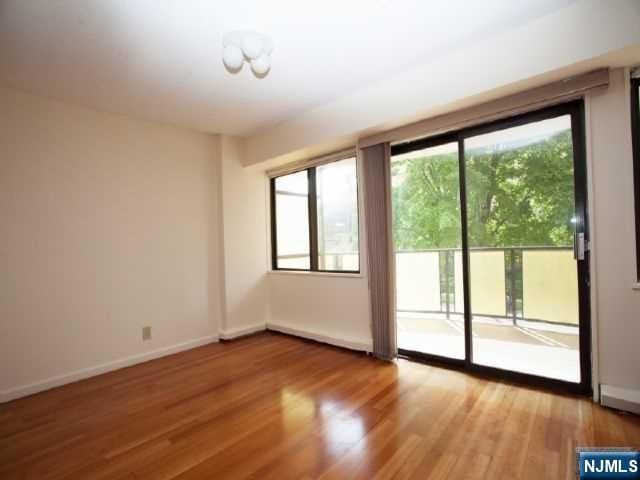 doorway with baseboards and wood finished floors