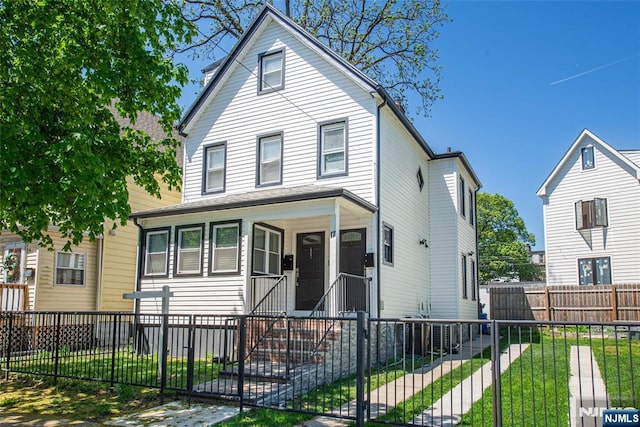 view of front facade with a fenced front yard and a front yard