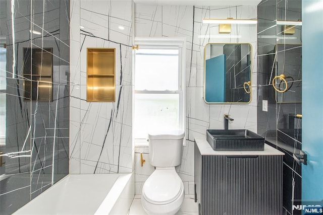 full bath featuring a sink, toilet, and tile walls