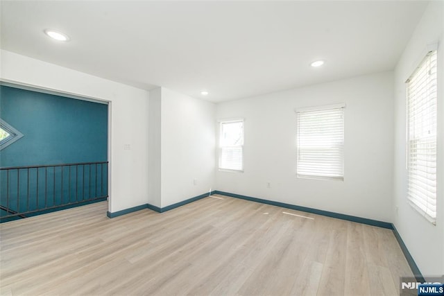 unfurnished room featuring recessed lighting, baseboards, and wood finished floors