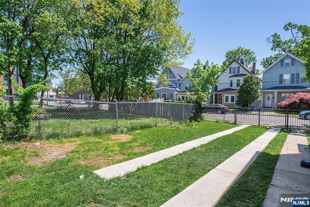 view of yard with fence and a residential view
