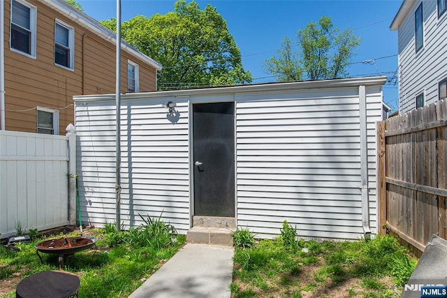 view of outbuilding featuring an outdoor structure and fence