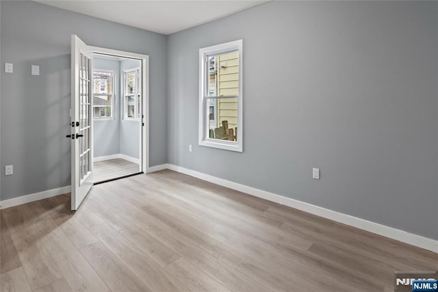 entryway with baseboards, french doors, and wood finished floors